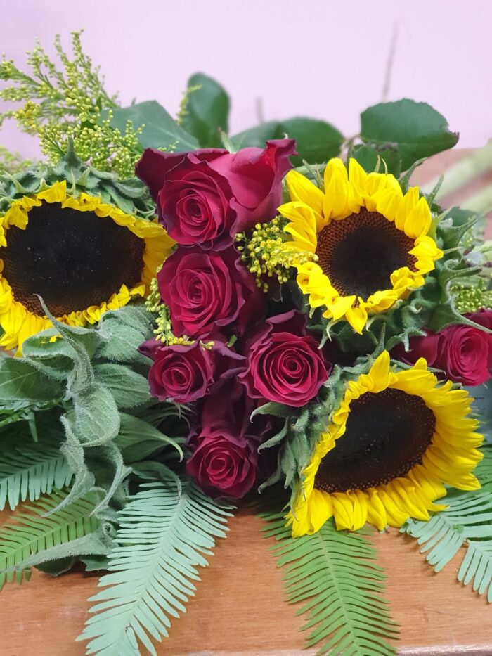 Nothing is more happy than sunflowers. So this bouquet will make anyone smile and lets add some roses for an even better results.