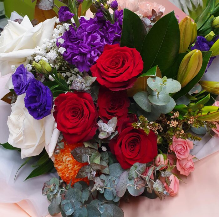 Seasonal flowers with roses all put beautiful together in a bouquet.